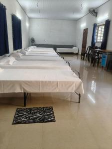 a row of beds in a large room at Lagoon lake view in Kollam