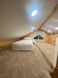 a bedroom with a bed in a attic at Cozy stream-side cabin in Lanesborough