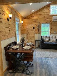 a dining room with a table and chairs at Cozy stream-side cabin in Lanesborough