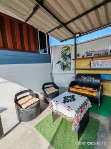 a garage with two chairs and a couch and a table at nature in Ban Rong Koet