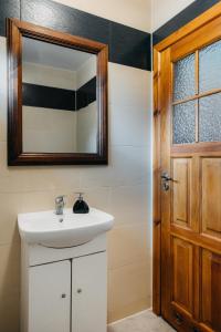 a bathroom with a sink and a mirror at Domki nad potokiem in Susiec +36 photos
