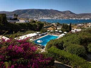 a swimming pool with a view of the water and mountains at Akrotiri Hotel in Parikia
