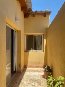 an outside view of a house with a window at Cabañas Luna y Sol in Cafayate