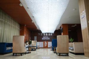 a lobby with chairs and a large white ceiling at Hotel Arai Plaza in Taraz +113 photos