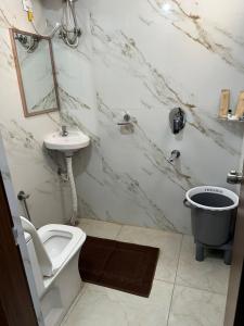 a bathroom with a toilet and a sink at Hotel Apex Inn Hyderabad Airport in Hyderabad +17 photos