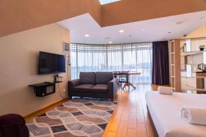 a living room with a couch and a table at Bangi Perdana Hotel in Bangi