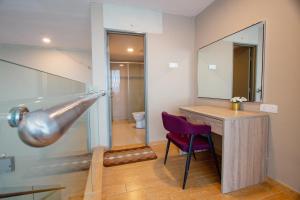 a bathroom with a sink and a desk and a mirror at Bangi Perdana Hotel in Bangi +131 photos