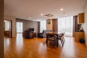 a living room with a table and chairs and a couch at Bangi Perdana Hotel in Bangi