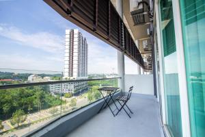 a balcony with a table and chairs on a building at Bangi Perdana Hotel in Bangi