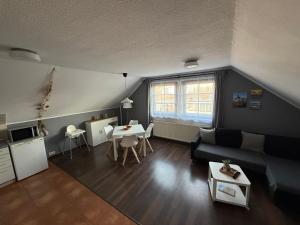a living room with a couch and a table at Strandgut- die Kleine in Dranske +10 photos