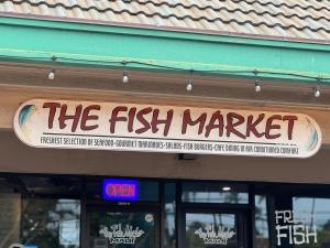 a sign for the fish market on the front of a store at Napili Shores D126 · NSD126 Cozy Studio Steps to Beach in Kahana