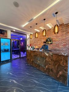 a man sitting at a bar in a restaurant at Gulberg Inn Hotel Lahore in Lahore +88 photos