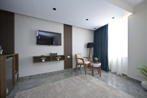 a living room with a tv on the wall at Delta Pyramids Hotel in Giza