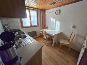 a kitchen with a table and a dining room at Adli in Disentis