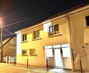 a building with doors and windows on a street at Duplex in Escaudain