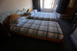two twin beds in a room with at Annie's Bed & Breakfast in South Shields