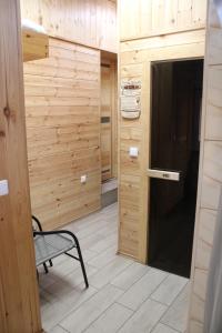a door to a room with a bench in a room at Mažasis SPA in Merkinė