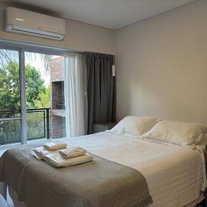 a bedroom with a bed with two towels on it at TOLHUIN COLON in Colón +73 photos