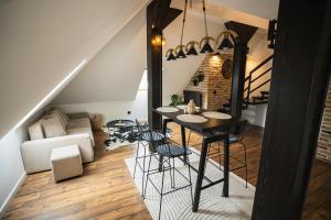 a living room with a table and chairs in a room at Promenada Apartmani Zlatibor in Zlatibor