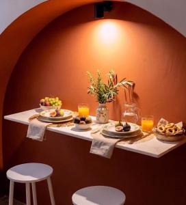 a table with plates of food and glasses of orange juice at Desideri di Puglia in Barletta