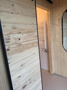 a door in a room with a wooden wall at New listing - Krosshóll Cottage, built in 2026 in Hella
