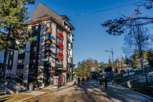 a street with a building on the side of the road at Promenada Apartmani Zlatibor in Zlatibor