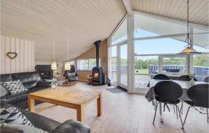 a living room with a couch and a table at Amazing Home In Tarm With Sauna in Tarm