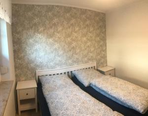 a bedroom with two beds and two night stands at Sommerwiese in Prerow
