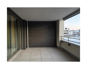 a balcony of a building with a brick wall at Zuhause am Bodensee in Bottighofen