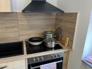 a kitchen with two pots and pans on a stove at Ferienwohnung Andi in Gerolstein
