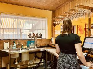 a woman standing in a kitchen with a sink at Camp Litomerice in Litoměřice +7 photos