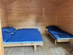 a bedroom with two beds in a wooden room at Camp Litomerice in Litoměřice