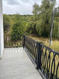 a balcony with a black fence and trees at Alvina 29 in Tsaghkadzor