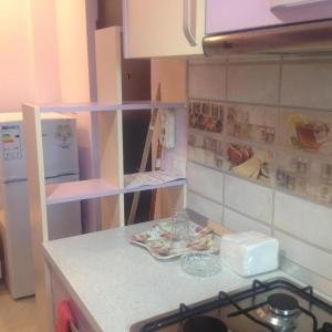a kitchen with a stove and a counter top at KM 0 one RESIDENCE in Piatra Neamţ
