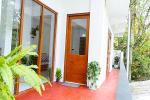 a front door of a house with plants at Ella Flower Zone Holiday Resort in Bandarawela +10 photos