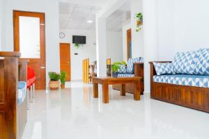a living room with a couch and a table at Ella Flower Zone Holiday Resort in Bandarawela