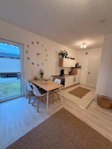 a kitchen and dining room with a table and chairs at Gemütliches Apartment in Kehl am Rhein