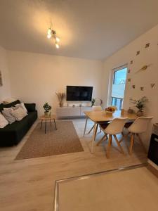a living room with a table and a couch at Gemütliches Apartment in Kehl am Rhein