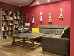 a living room with a couch and bookshelves at Dom pod Jaworem in Rajcza