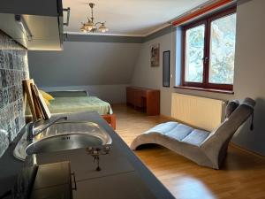 a bathroom with a sink and a bedroom with a bed at Dom pod Jaworem in Rajcza