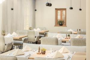 a restaurant with tables and chairs and a window at Engel Gourmet&Spa in Nova Levante