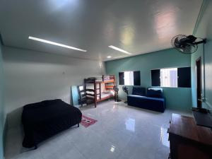 a living room with a bed and a couch at Casa de Férias com Piscina in Salinópolis