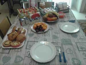a table with plates of bread and fruit on it at Lilla B&B in Molfetta