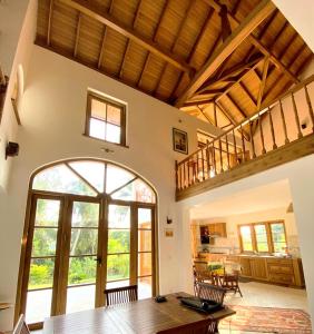 an open living room with a table and an open door at Luxury Cannelle lake villa in Hikkaduwa