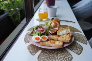 a plate of breakfast food on a table with a glass of orange juice at Hotel MOANA絶景オーシャンビューカフェラウンジ朝食付き in Oshima