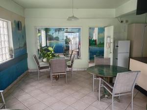 a kitchen and dining room with a table and chairs at Brackendene Lodge in Gaborone