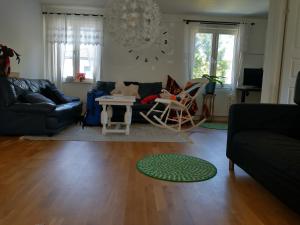 a living room with a couch and a table at Villa Bliss in Surte