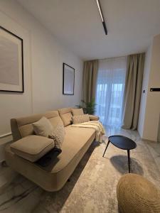 a living room with a couch and a table at Sotto Il Sole in Surčin