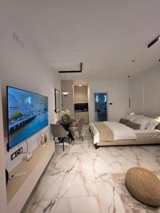 a bedroom with a large bed and a large television at Sotto Il Sole in Surčin