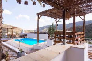 a villa with a swimming pool and mountains in the background at Villa Capital Mountainview in Carboneras